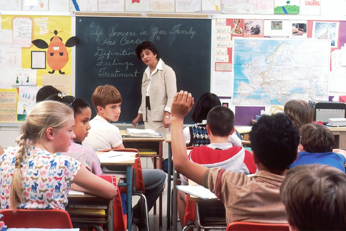 woman standing in front of children